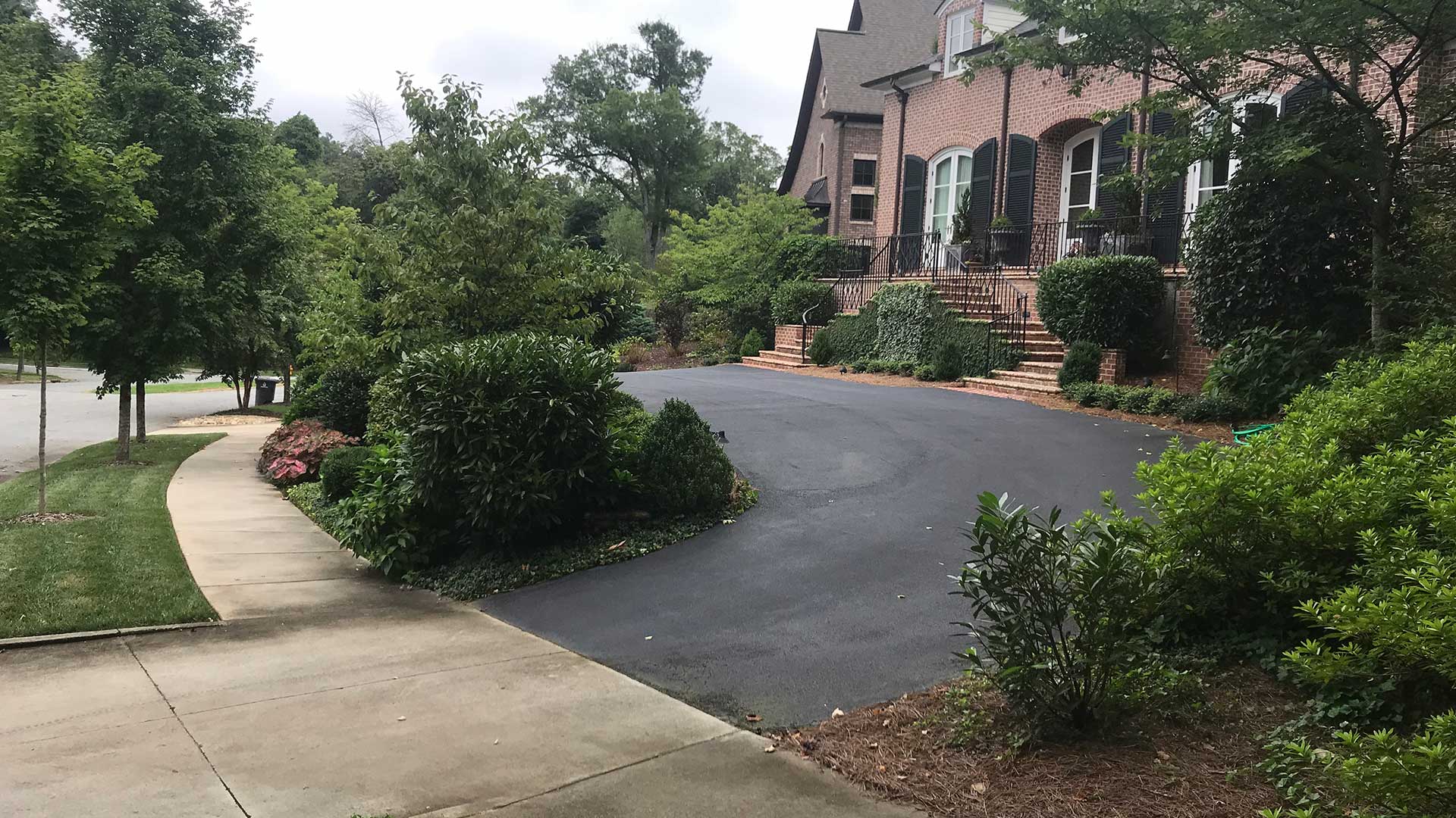 Beautiful landscaping with mulch beds and trimmed shrubs in Greensboro, NC.