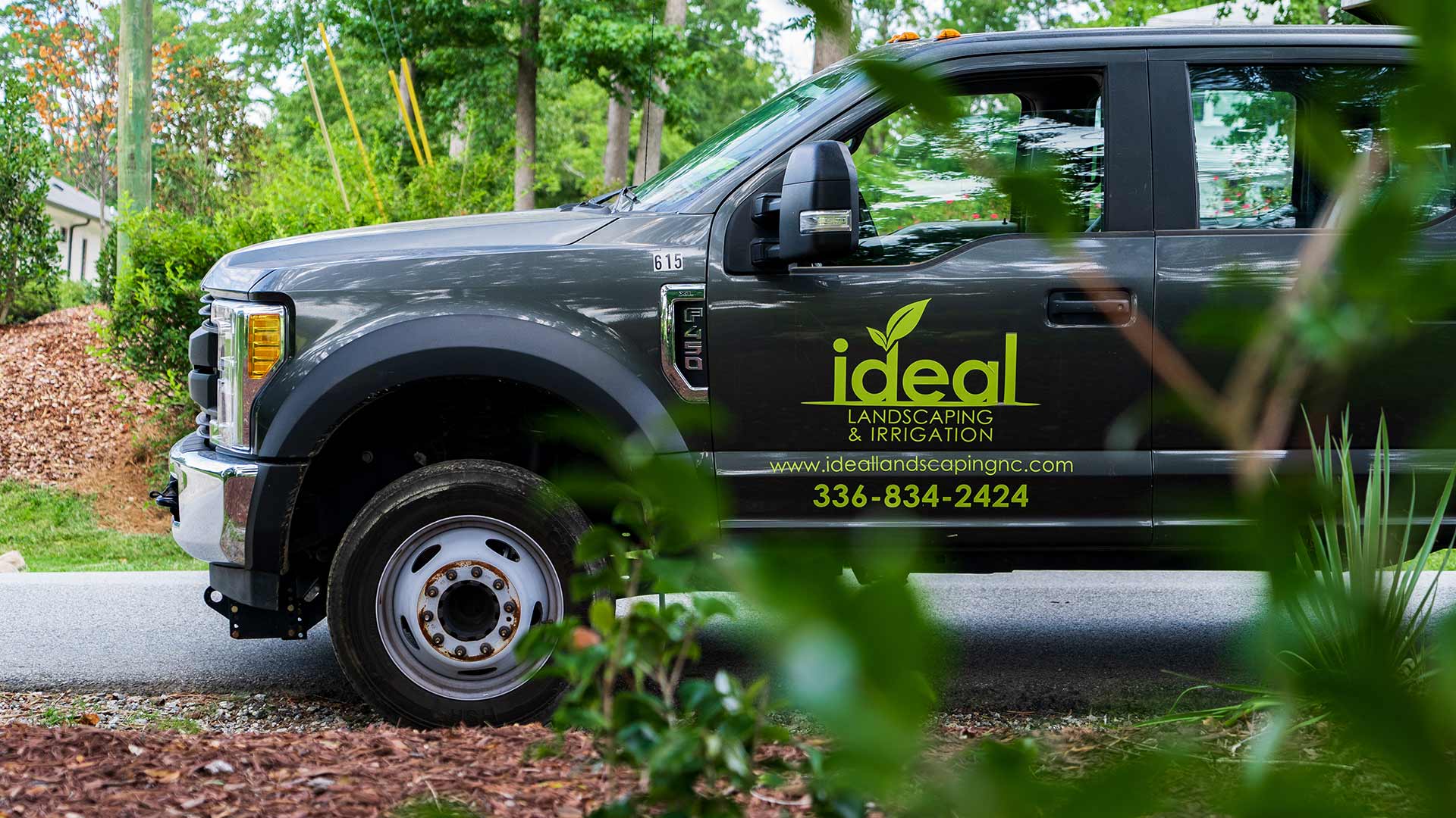 Ideal Landscaping & Irrigation service truck at a home in Greensboro, NC.