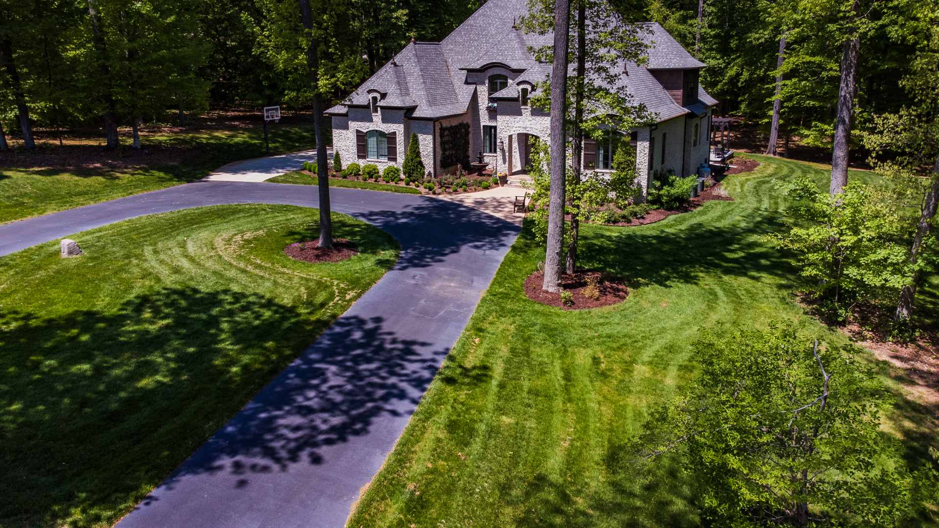 A large home with plenty of landscaping maintained by Ideal workers in Clemmons, NC.