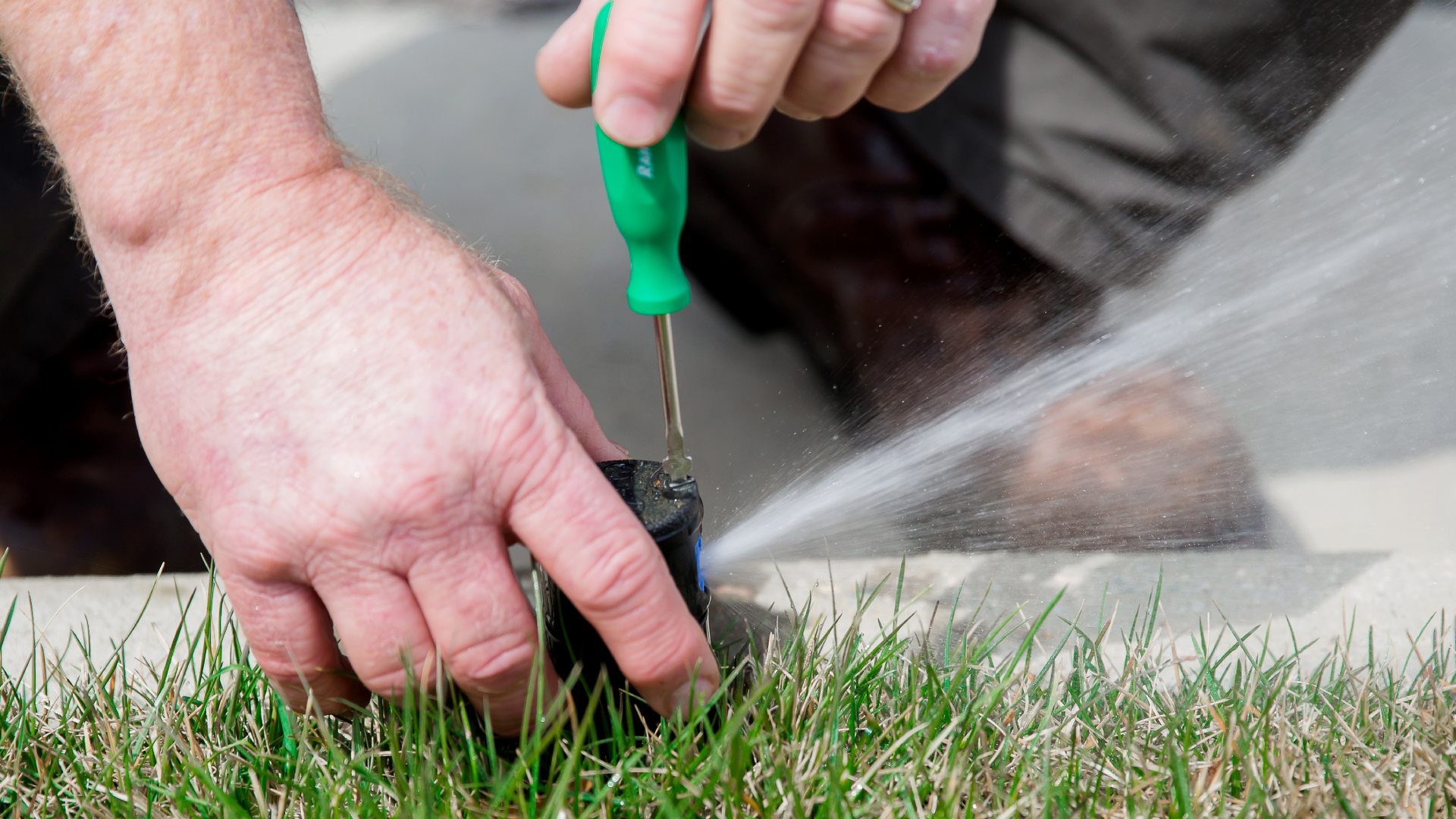 Professional performing irrigation repair in Greensboro, NC.