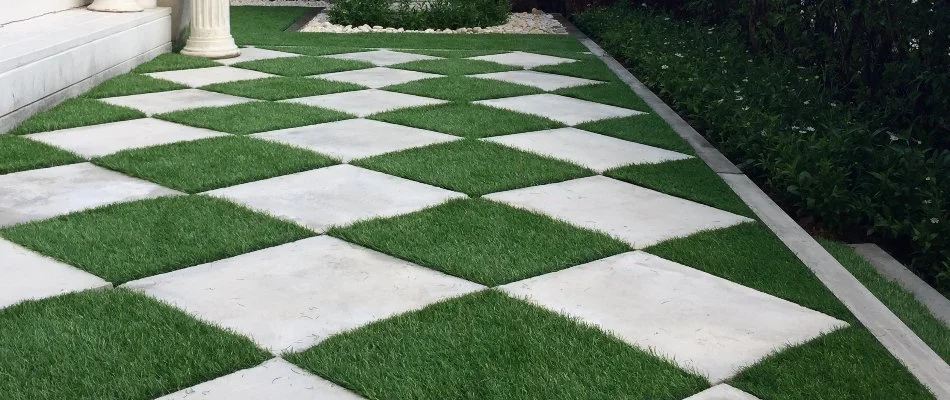 Artificial turf used as an accent for pavers in a landscape in Greensboro, NC.