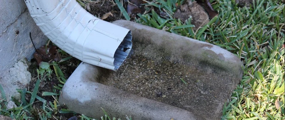 End of a downspout on the ground in Greensboro, NC.