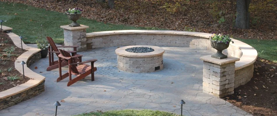 Patio in Greensboro, NC, with a fire pit and seating wall.