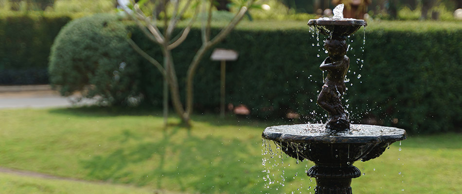 A black custom water fountain installed in our client's garden in Graham, NC.