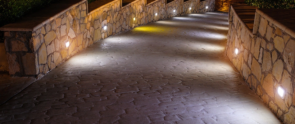 Night path lighting built into seating walls in Kernersville, NC.