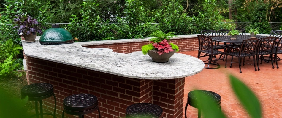 Outdoor kitchen installed with seating wall in Lewisville, NC.