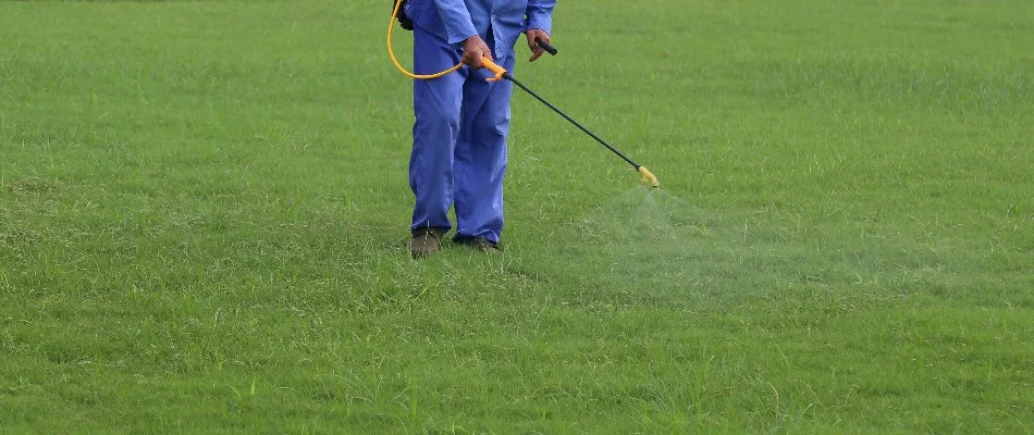 Our fertilization specialist spraying a treatment on our client's lawn in Oak Ridge, NC.
