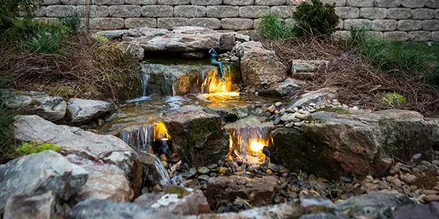 Custom water fall feature with stone and lighting near Greensboro, NC.