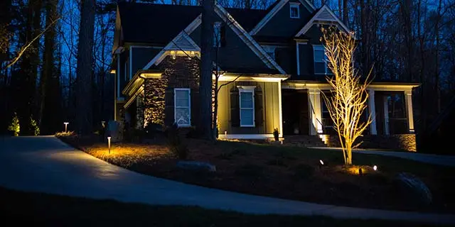House with outdoor lighting installed around the yard near Greensboro, NC.