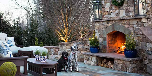 Outdoor fireplace and two cute dogs at a home in Greensboro, NC.