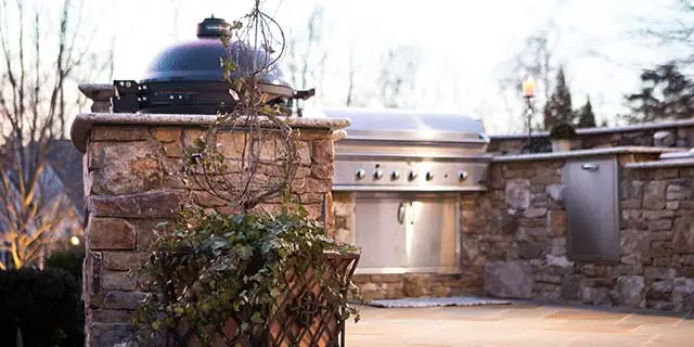 Outdoor kitchen with grill and patio area in Winston-Salem, NC.