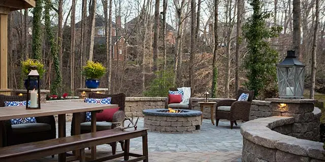 Patio with retaining and seating walls near fire pit in Greensboro, NC.