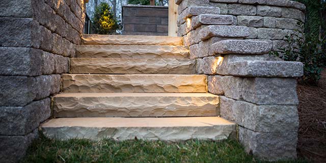 Natural stone steps with walls and outdoor lighting in Greensboro, NC.